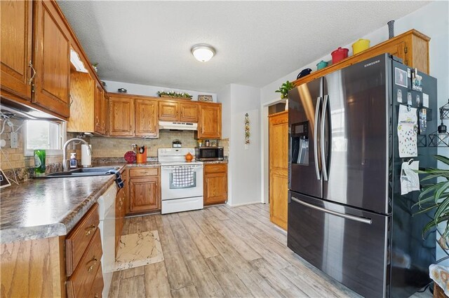 1453 Madison St, Lees Summit, MO 64081 - kitchen with appliances with stainless steel finishes, brown cabinets, and decorative backsplash