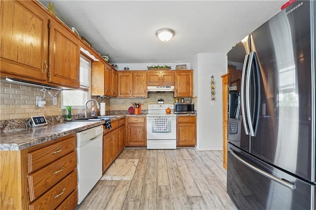 1453 Madison St, Lees Summit, MO 64081 - kitchen with stainless steel appliances, under cabinet range hood, and brown cabinets