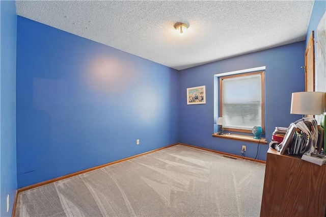 1453 Madison St, Lees Summit, MO 64081 - carpeted spare room featuring baseboards and a textured ceiling
