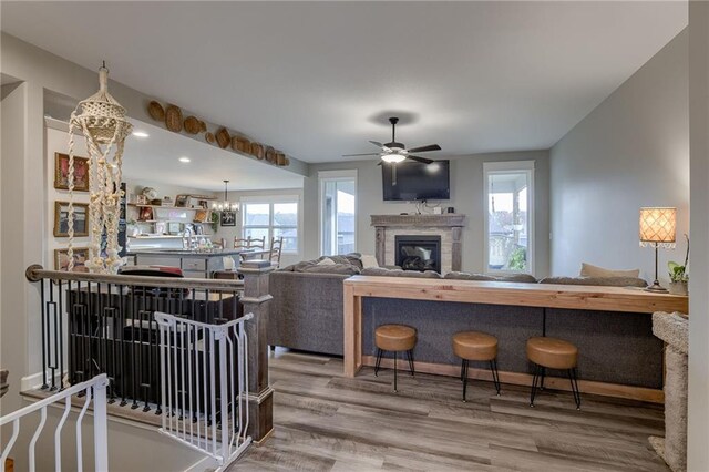 807 N Whispering Hills Dr, Lone Jack, MO 64070 - living room with ceiling fan, wood finished floors, a glass covered fireplace, and recessed lighting