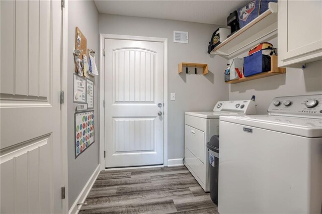 807 N Whispering Hills Dr, Lone Jack, MO 64070 - laundry room with cabinet space, washer and dryer, wood finished floors, and baseboards