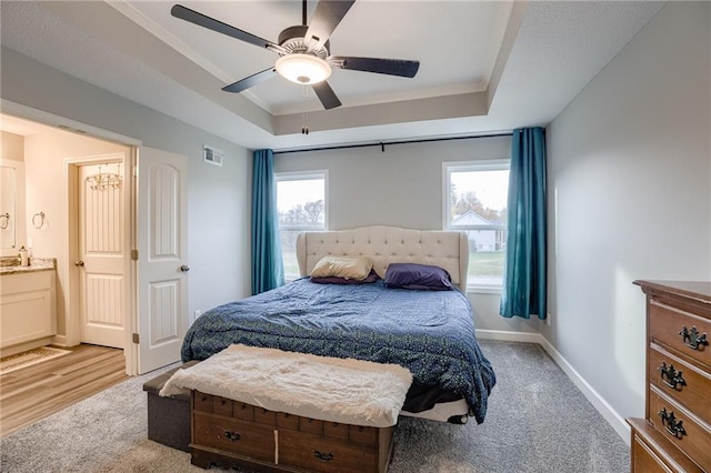 807 N Whispering Hills Dr, Lone Jack, MO 64070 - bedroom featuring a tray ceiling, baseboards, a ceiling fan, crown molding, and ensuite bathroom
