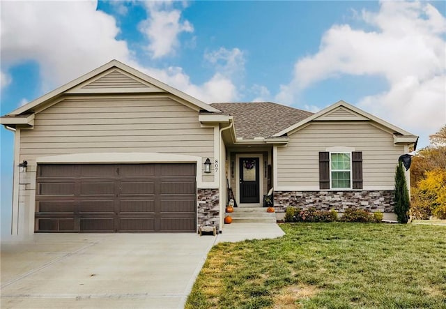 807 N Whispering Hills Dr, Lone Jack, MO 64070 - view of front of home featuring driveway, a front yard, a garage, stone siding, and roof with shingles