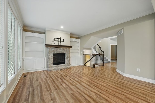 4904 W 162nd St, Overland Park, KS 66085 - unfurnished living room featuring stairs, light wood-type flooring, baseboards, a stone fireplace, and recessed lighting
