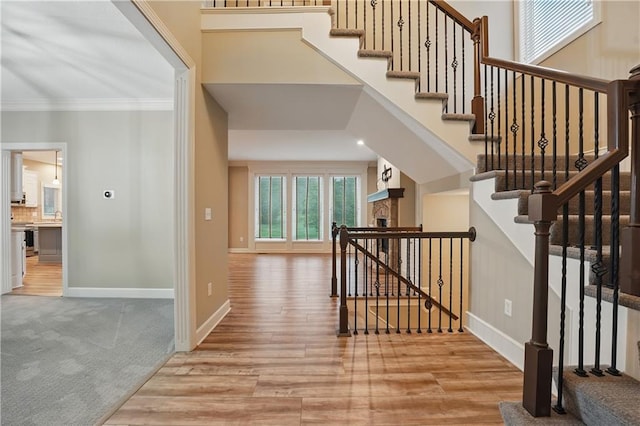 4904 W 162nd St, Overland Park, KS 66085 - stairway featuring ornamental molding, wood finished floors, baseboards, and carpet floors
