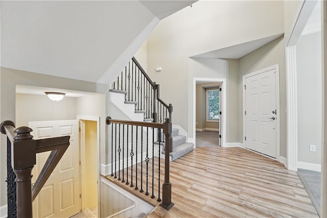4904 W 162nd St, Overland Park, KS 66085 - foyer featuring light wood-type flooring, lofted ceiling, baseboards, and stairway