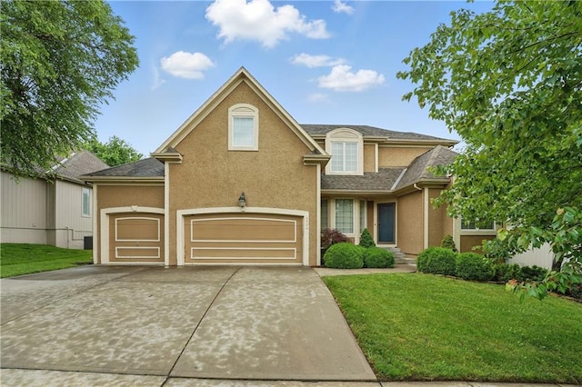 4904 W 162nd St, Overland Park, KS 66085 - traditional-style home featuring a front lawn, driveway, stucco siding, roof with shingles, and an attached garage