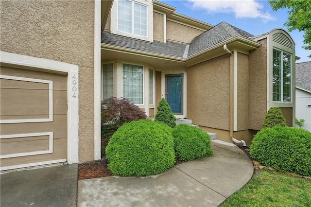 4904 W 162nd St, Overland Park, KS 66085 - doorway to property with stucco siding and a shingled roof