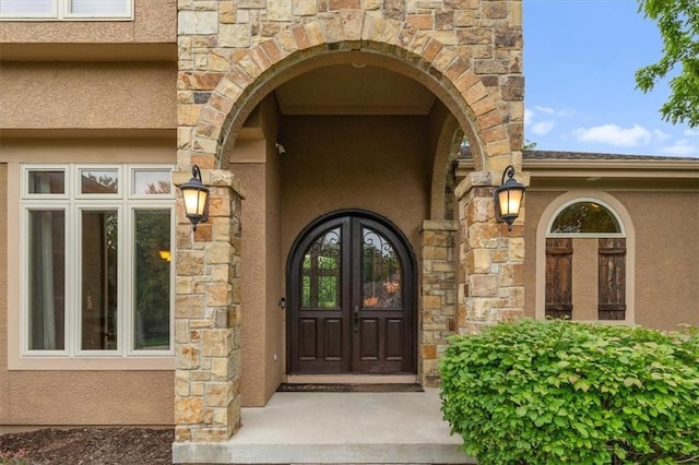 11121 S Whitetail Ln, Olathe, KS 66061 - entrance to property featuring stucco siding, stone siding, and french doors