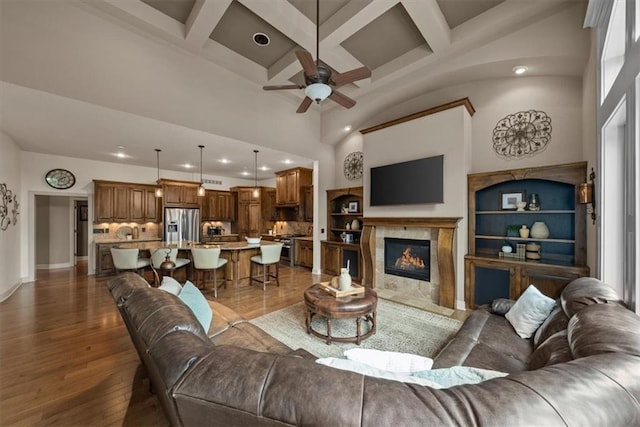 11121 S Whitetail Ln, Olathe, KS 66061 - living area with recessed lighting, ceiling fan, coffered ceiling, dark wood finished floors, and a high end fireplace