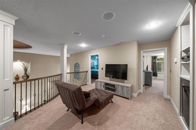 11121 S Whitetail Ln, Olathe, KS 66061 - carpeted living room featuring a textured ceiling and ornate columns