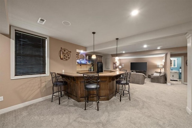 11121 S Whitetail Ln, Olathe, KS 66061 - indoor wet bar with light carpet, freestanding refrigerator, recessed lighting, and decorative light fixtures