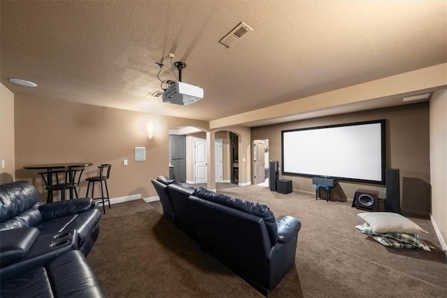 11121 S Whitetail Ln, Olathe, KS 66061 - home theater room with a textured ceiling, arched walkways, and carpet flooring