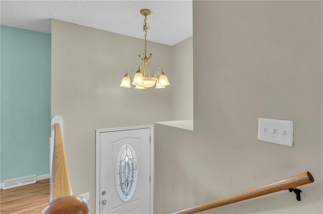 531 S Oak St, Gardner, KS 66030 - entryway featuring a chandelier, wood finished floors, and baseboards