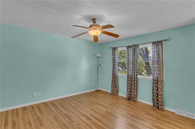 531 S Oak St, Gardner, KS 66030 - spare room with wood finished floors, ceiling fan, a textured ceiling, and baseboards