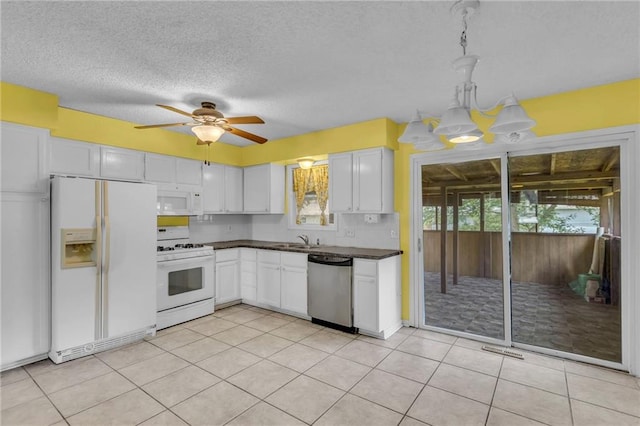 531 S Oak St, Gardner, KS 66030 - kitchen featuring white appliances, dark countertops, a sink, white cabinets, and a textured ceiling