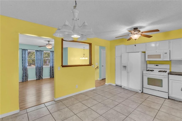 531 S Oak St, Gardner, KS 66030 - kitchen with white appliances, a ceiling fan, a chandelier, white cabinets, and a textured ceiling