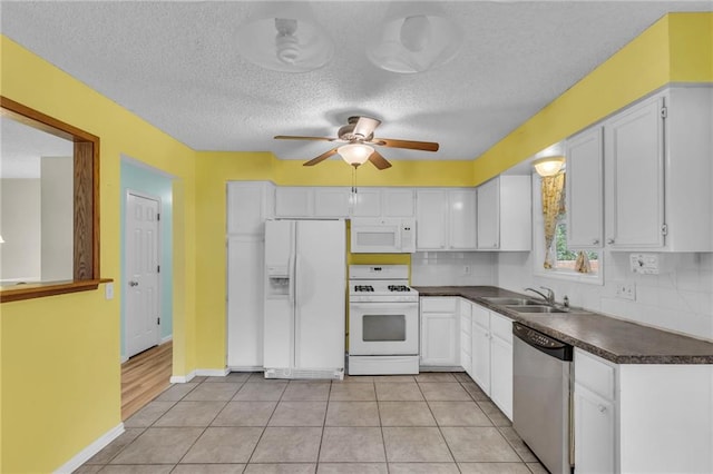 531 S Oak St, Gardner, KS 66030 - kitchen with white appliances, dark countertops, a sink, white cabinetry, and a ceiling fan