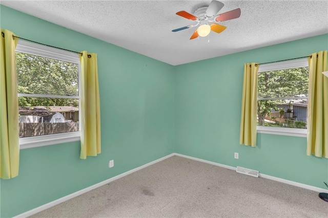 531 S Oak St, Gardner, KS 66030 - carpeted spare room featuring baseboards, a textured ceiling, and a ceiling fan