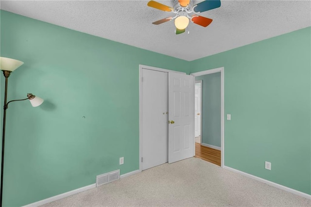 531 S Oak St, Gardner, KS 66030 - unfurnished bedroom with baseboards, carpet floors, ceiling fan, and a textured ceiling