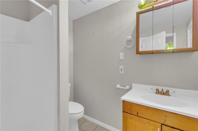 531 S Oak St, Gardner, KS 66030 - bathroom featuring toilet, vanity, tile patterned flooring, a shower, and baseboards
