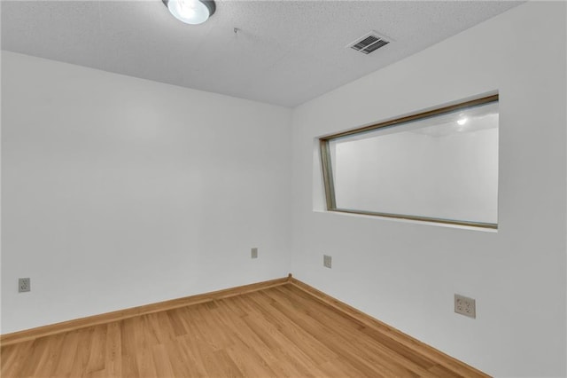 531 S Oak St, Gardner, KS 66030 - empty room featuring wood finished floors, baseboards, and a textured ceiling