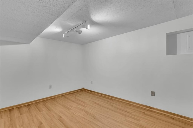 531 S Oak St, Gardner, KS 66030 - unfurnished room featuring wood finished floors, rail lighting, and baseboards