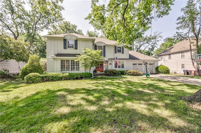 8911 W 105th Ter, Overland Park, KS 66212 - traditional-style home featuring an attached garage, driveway, a front yard, and board and batten siding