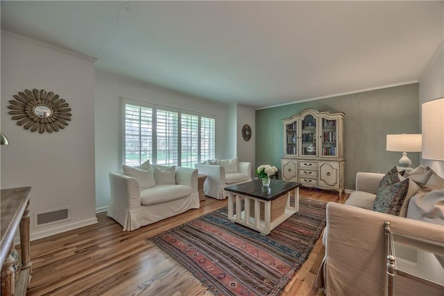 8911 W 105th Ter, Overland Park, KS 66212 - living area featuring wood finished floors, crown molding, and baseboards