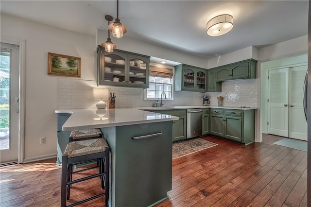 8911 W 105th Ter, Overland Park, KS 66212 - kitchen featuring green cabinetry, a peninsula, light countertops, and dark wood-type flooring