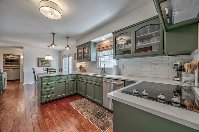 8911 W 105th Ter, Overland Park, KS 66212 - kitchen featuring green cabinets, dishwasher, a peninsula, a sink, and dark wood finished floors