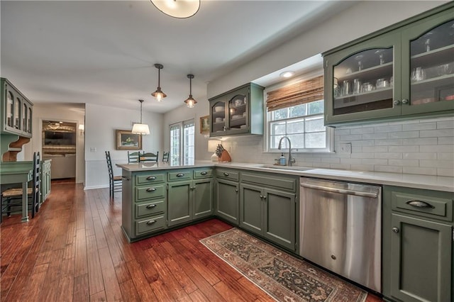 8911 W 105th Ter, Overland Park, KS 66212 - kitchen featuring stainless steel dishwasher, green cabinets, a sink, a peninsula, and light countertops