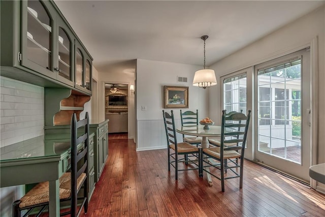 8911 W 105th Ter, Overland Park, KS 66212 - dining area featuring dark wood finished floors and a wainscoted wall