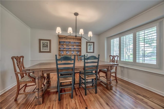 8911 W 105th Ter, Overland Park, KS 66212 - dining room with ornamental molding, wood finished floors, baseboards, and a chandelier
