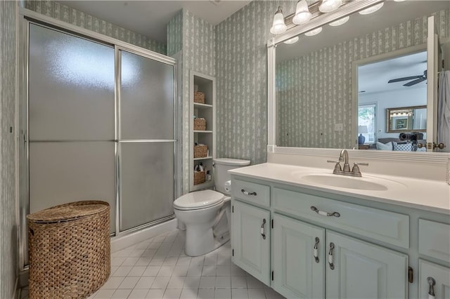 8911 W 105th Ter, Overland Park, KS 66212 - bathroom with wallpapered walls, toilet, vanity, a stall shower, and tile patterned floors