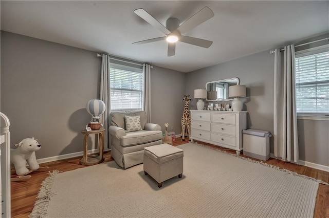 8911 W 105th Ter, Overland Park, KS 66212 - sitting room with light wood-style floors, a ceiling fan, healthy amount of natural light, and baseboards