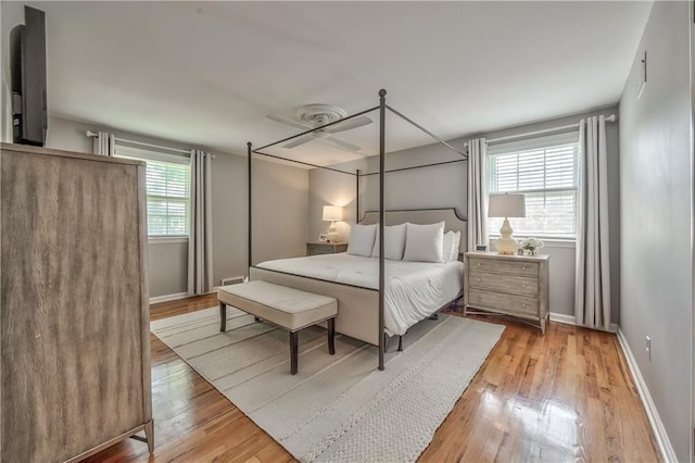 8911 W 105th Ter, Overland Park, KS 66212 - bedroom with light wood finished floors, baseboards, and ceiling fan