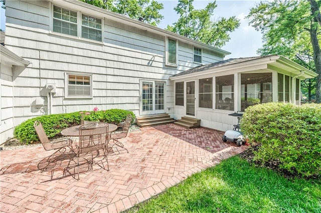 8911 W 105th Ter, Overland Park, KS 66212 - rear view of house with entry steps, a patio area, and a sunroom
