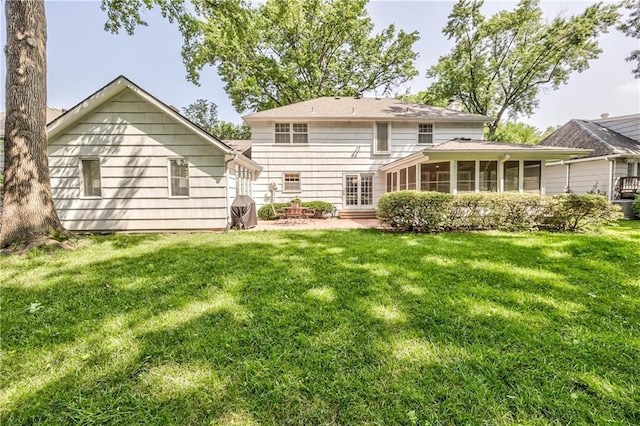 8911 W 105th Ter, Overland Park, KS 66212 - rear view of property featuring a sunroom, a yard, and a patio
