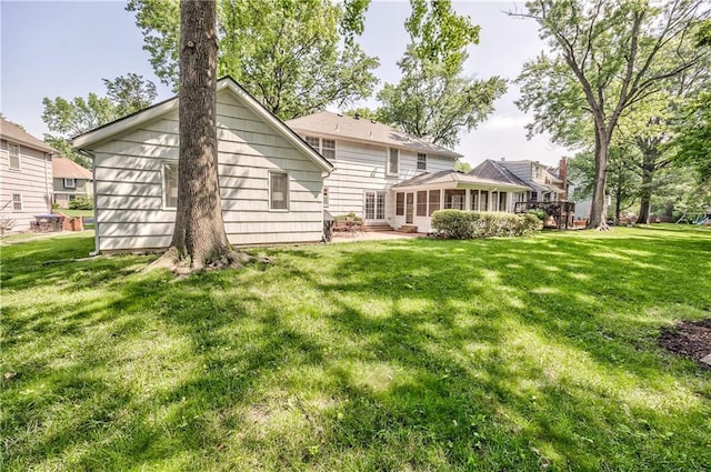 8911 W 105th Ter, Overland Park, KS 66212 - back of house with a sunroom and a yard