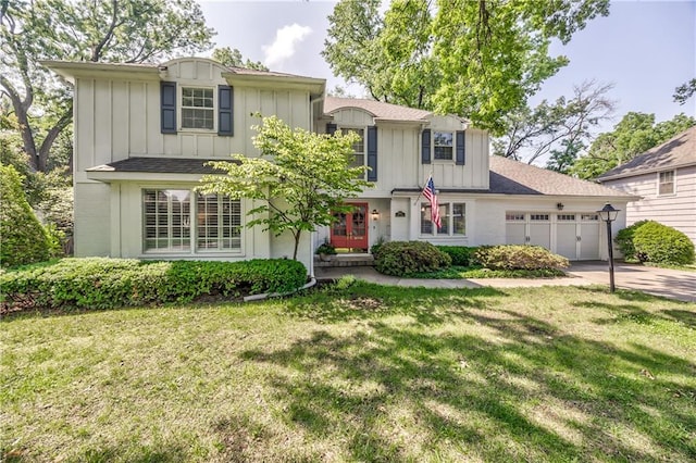 8911 W 105th Ter, Overland Park, KS 66212 - traditional home featuring board and batten siding, an attached garage, concrete driveway, and a front lawn