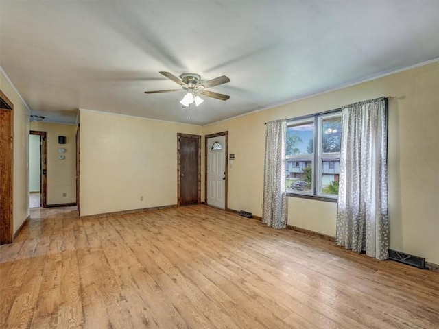 610 Morgan St, Lansing, KS 66043 - unfurnished living room with light wood-style flooring, a ceiling fan, baseboards, and crown molding