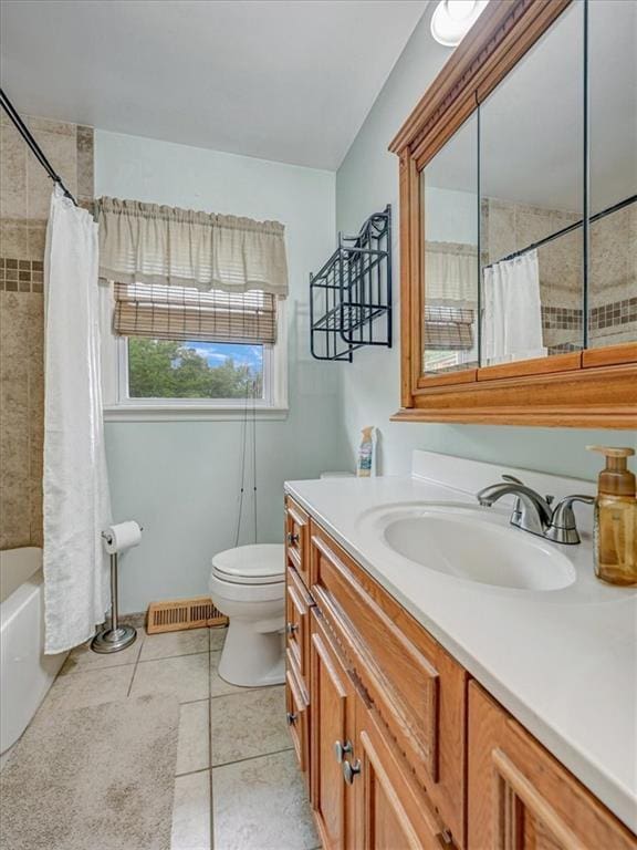 610 Morgan St, Lansing, KS 66043 - full bathroom with vanity, toilet, tile patterned flooring, and shower / bath combo with shower curtain