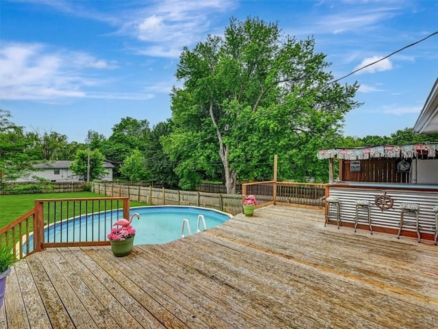 610 Morgan St, Lansing, KS 66043 - view of swimming pool with a wooden deck and view of wooded area
