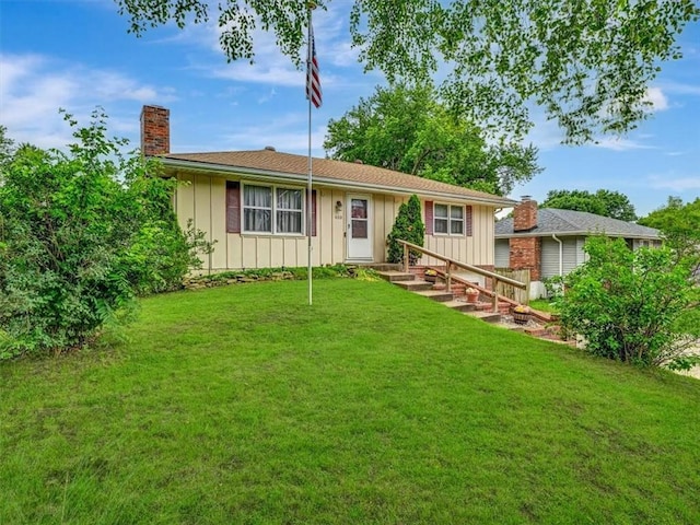 610 Morgan St, Lansing, KS 66043 - ranch-style house featuring board and batten siding, a chimney, and a front lawn