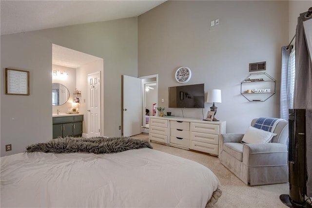 8961 Swarner Dr, Lenexa, KS 66219 - bedroom with light carpet, high vaulted ceiling, and ensuite bath