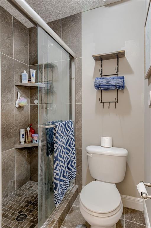 8961 Swarner Dr, Lenexa, KS 66219 - bathroom featuring a stall shower and tile patterned floors