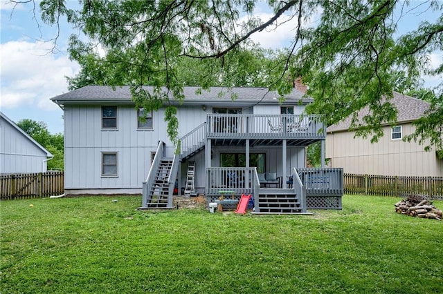 8961 Swarner Dr, Lenexa, KS 66219 - back of house featuring a deck, stairway, a fenced backyard, and board and batten siding