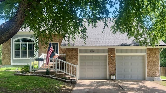 8961 Swarner Dr, Lenexa, KS 66219 - tri-level home with driveway, a garage, and brick siding