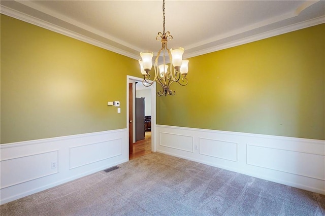 1404 NE Piedmont Dr, Lees Summit, MO 64064 - carpeted empty room featuring a chandelier, ornamental molding, wainscoting, and a decorative wall